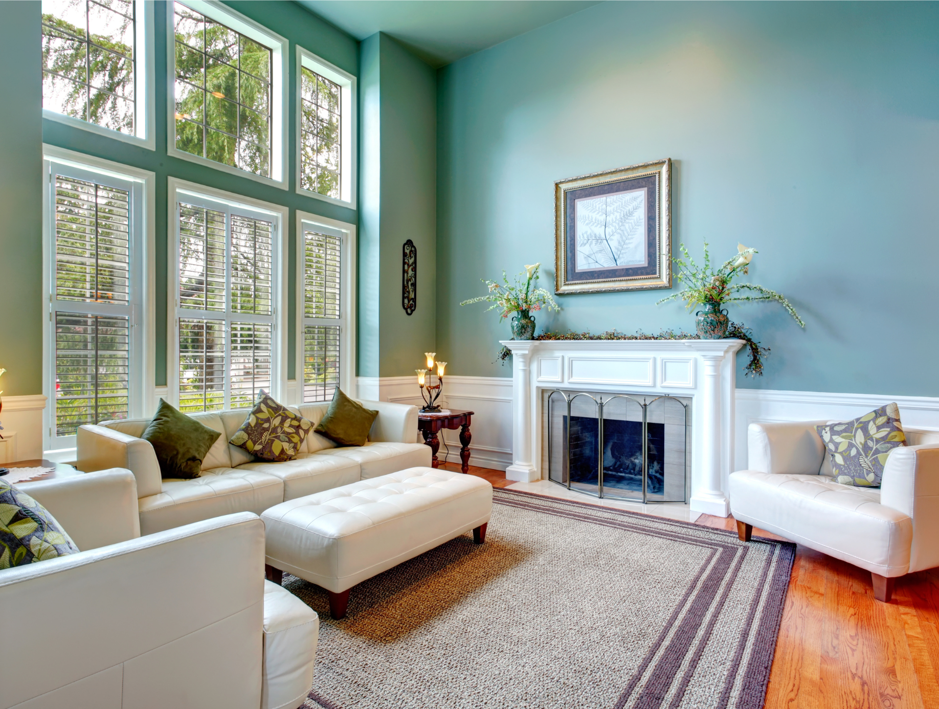 A living room with a fireplace and lots of windows