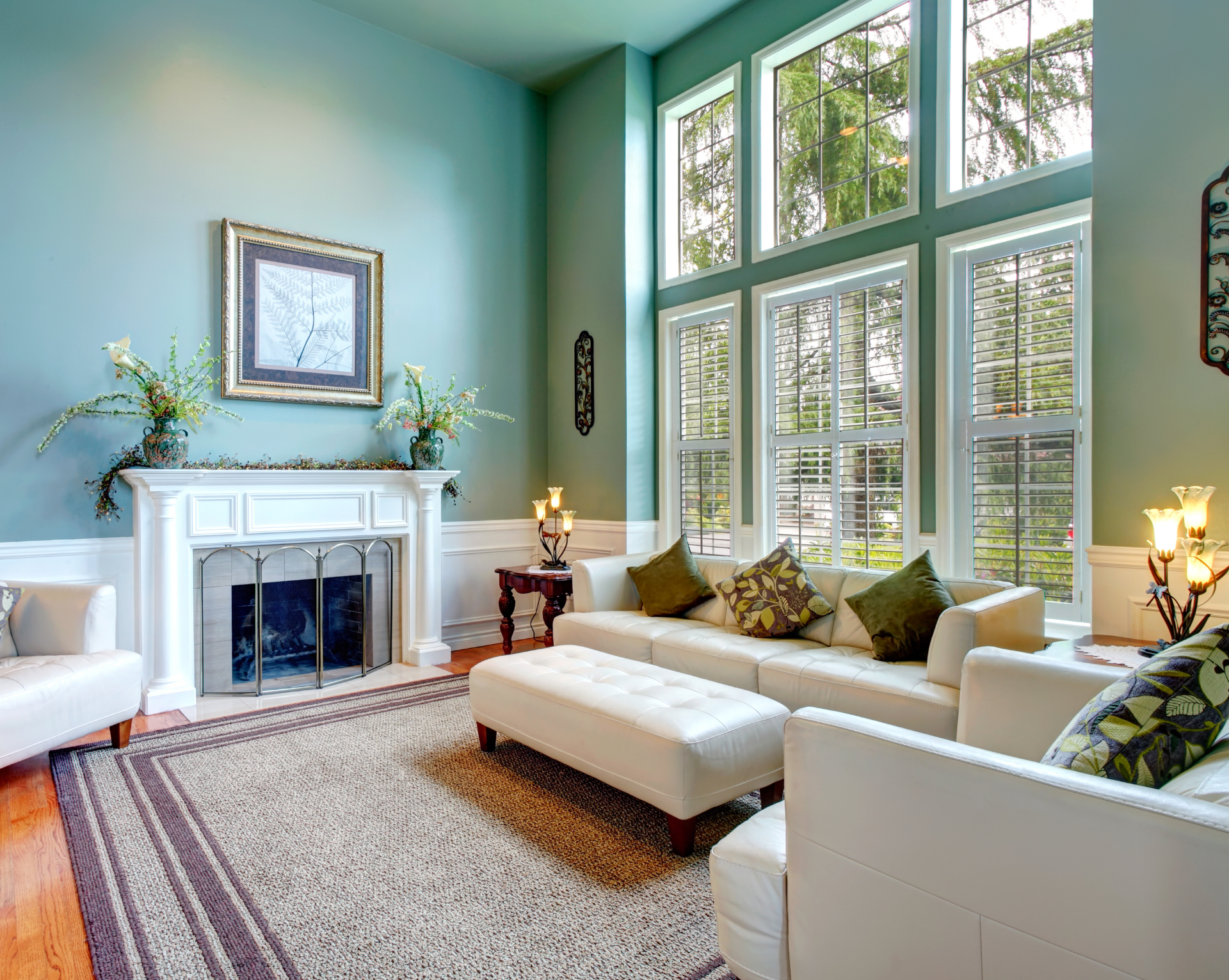 A living room with a fireplace and lots of windows