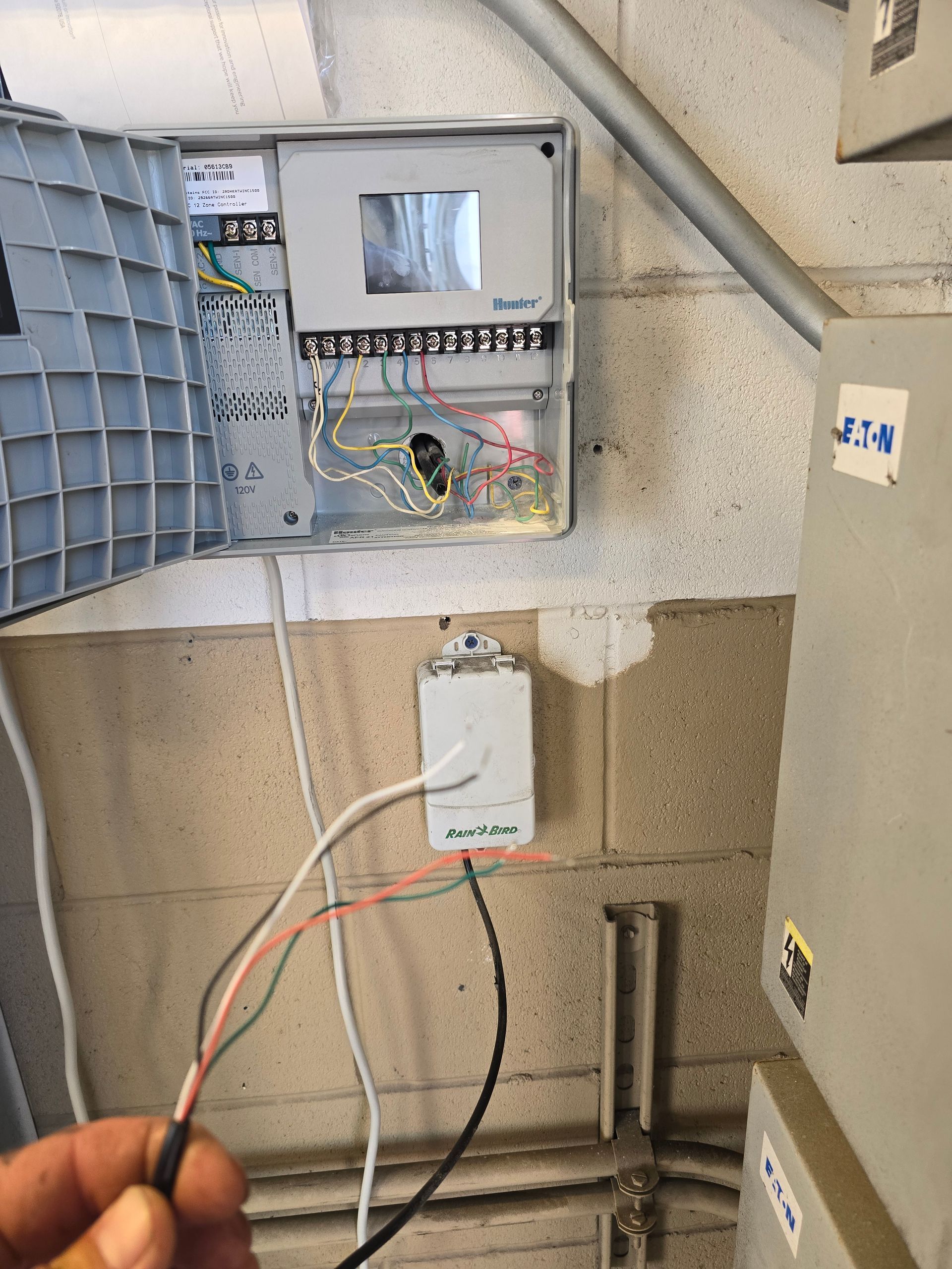 A sprinkler is spraying water on a lush green field. MT Landscaping Service