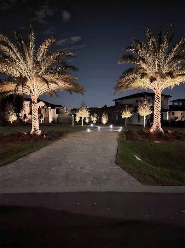 A backyard with a table and chairs under an umbrella. MT Landscaping Service