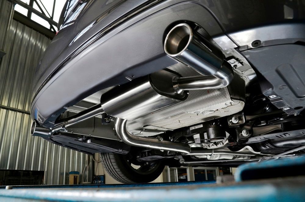 The Exhaust Pipe Of A Car Is Sitting On A Lift In A Garage — Mullumbimby Automotive in Mullumbimby, NSW