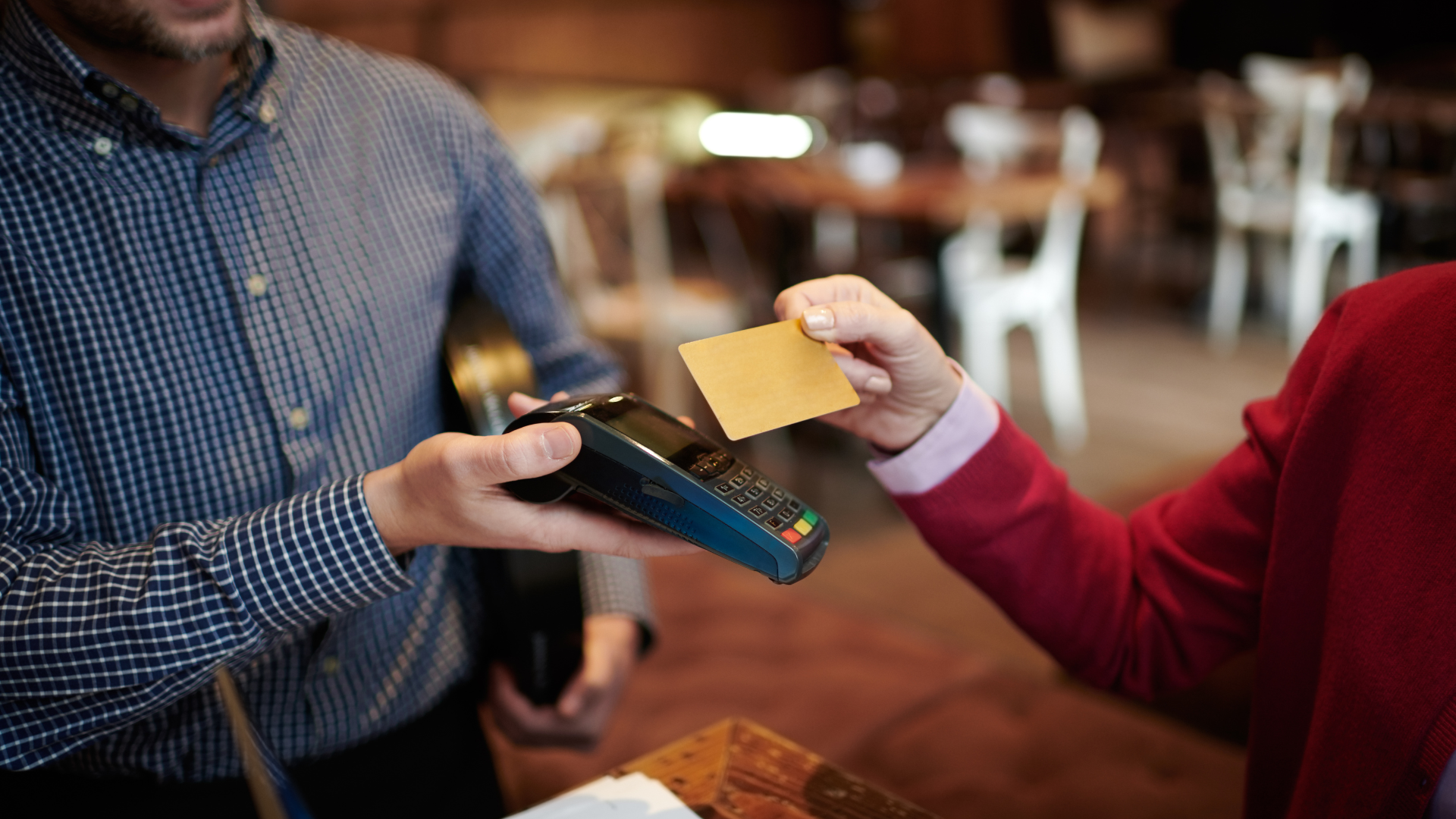 A man is paying with a credit card in a restaurant.