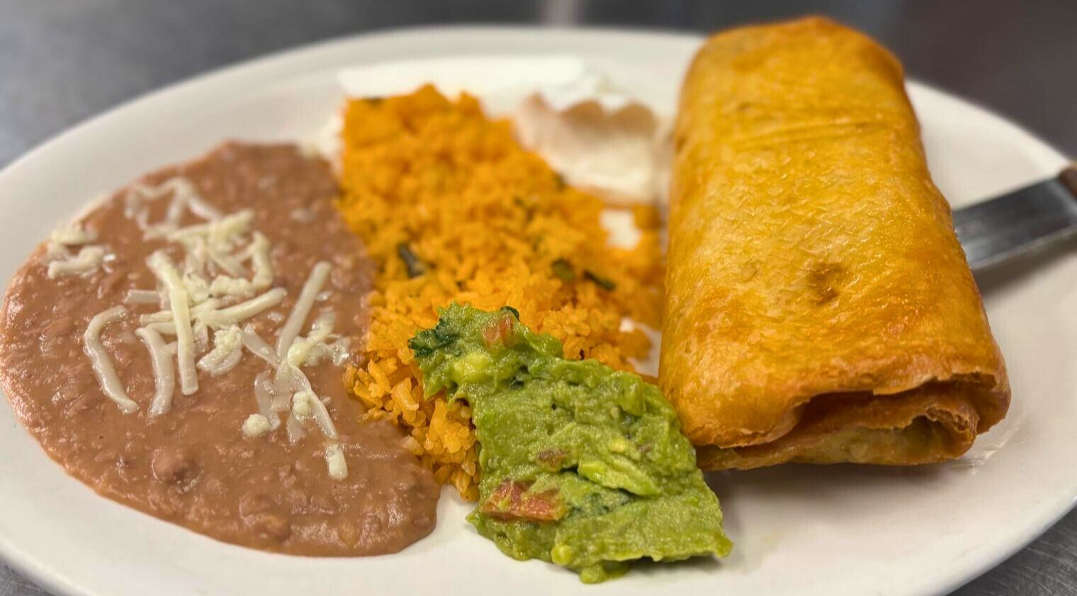 Golden chimichanga plate with rice and beans