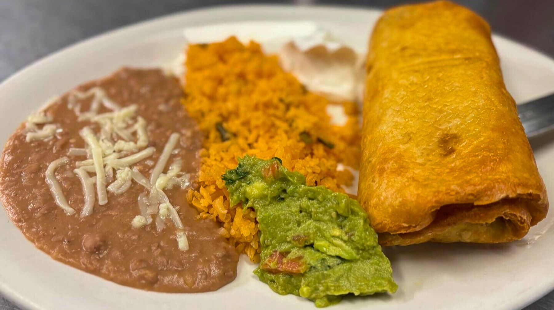 Golden chimichanga plate with rice and beans