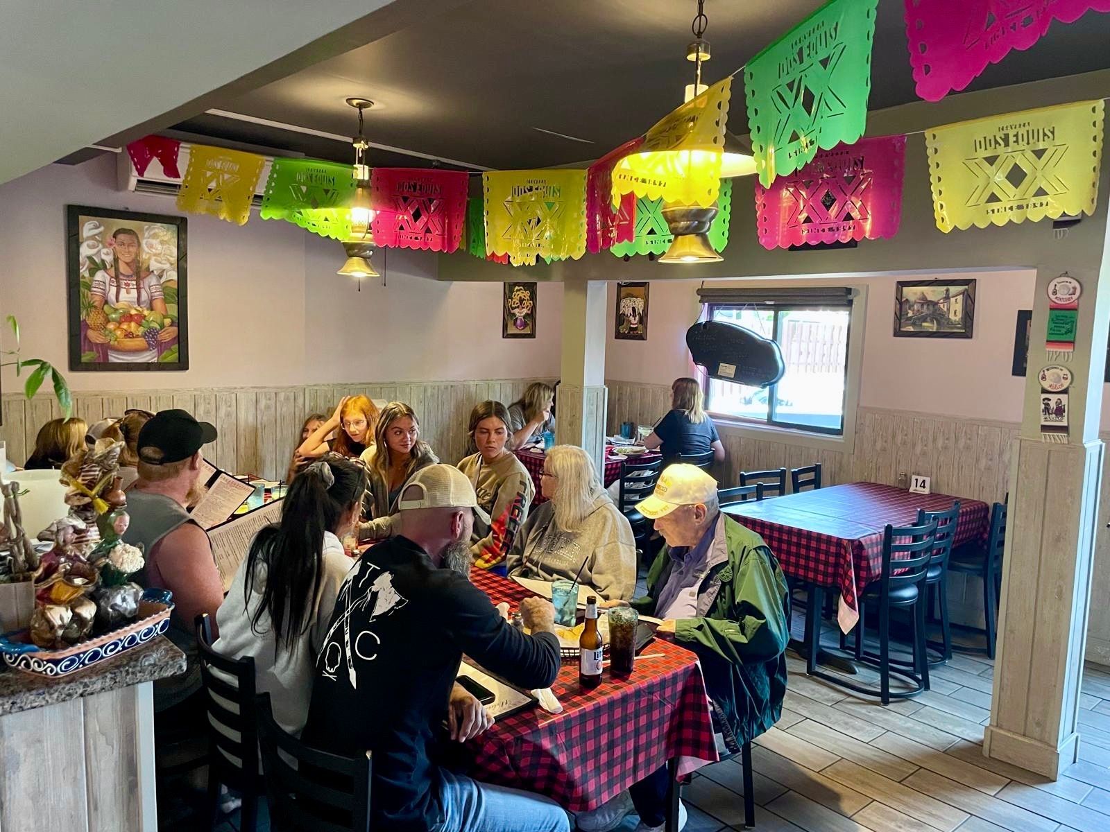 Busy El Sureño dining room with guests and warm ceiling lights