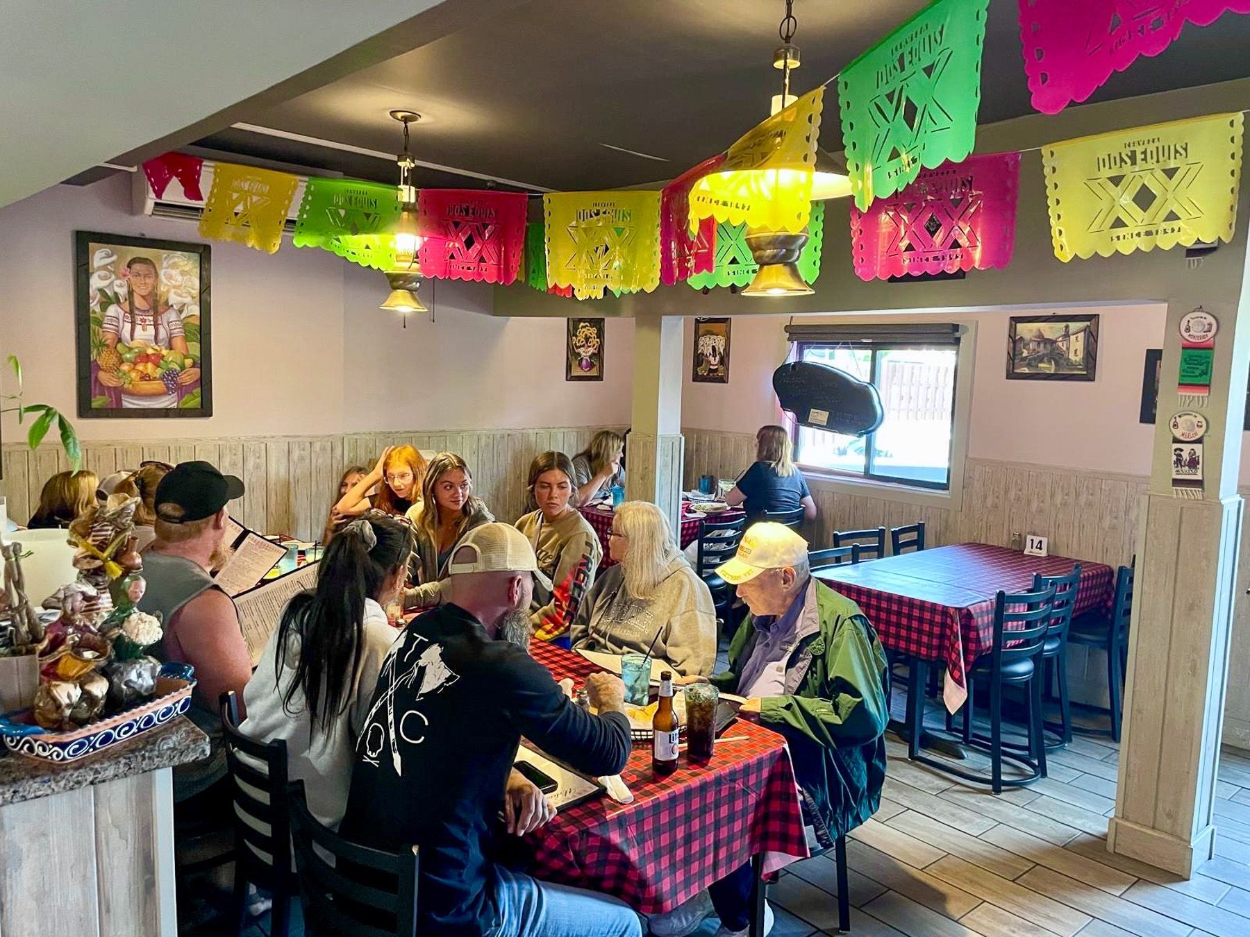 Busy El Sureño dining room with guests and warm ceiling lights