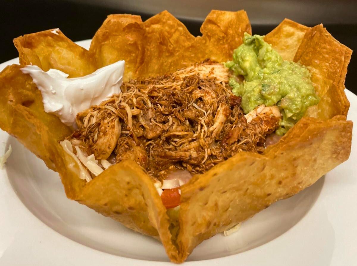 Chicken taco salad in a crisp tortilla bowl