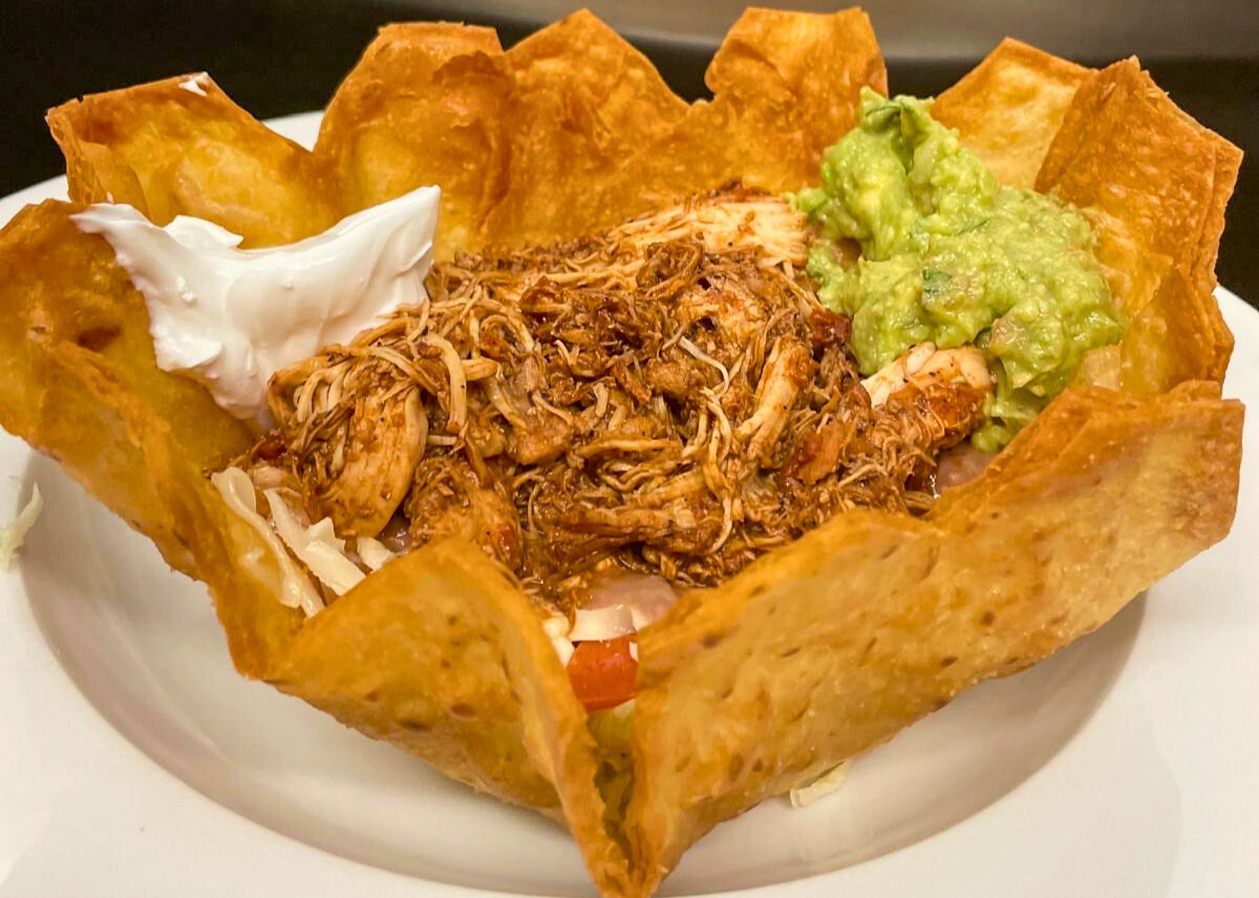 Chicken taco salad in a crisp tortilla bowl