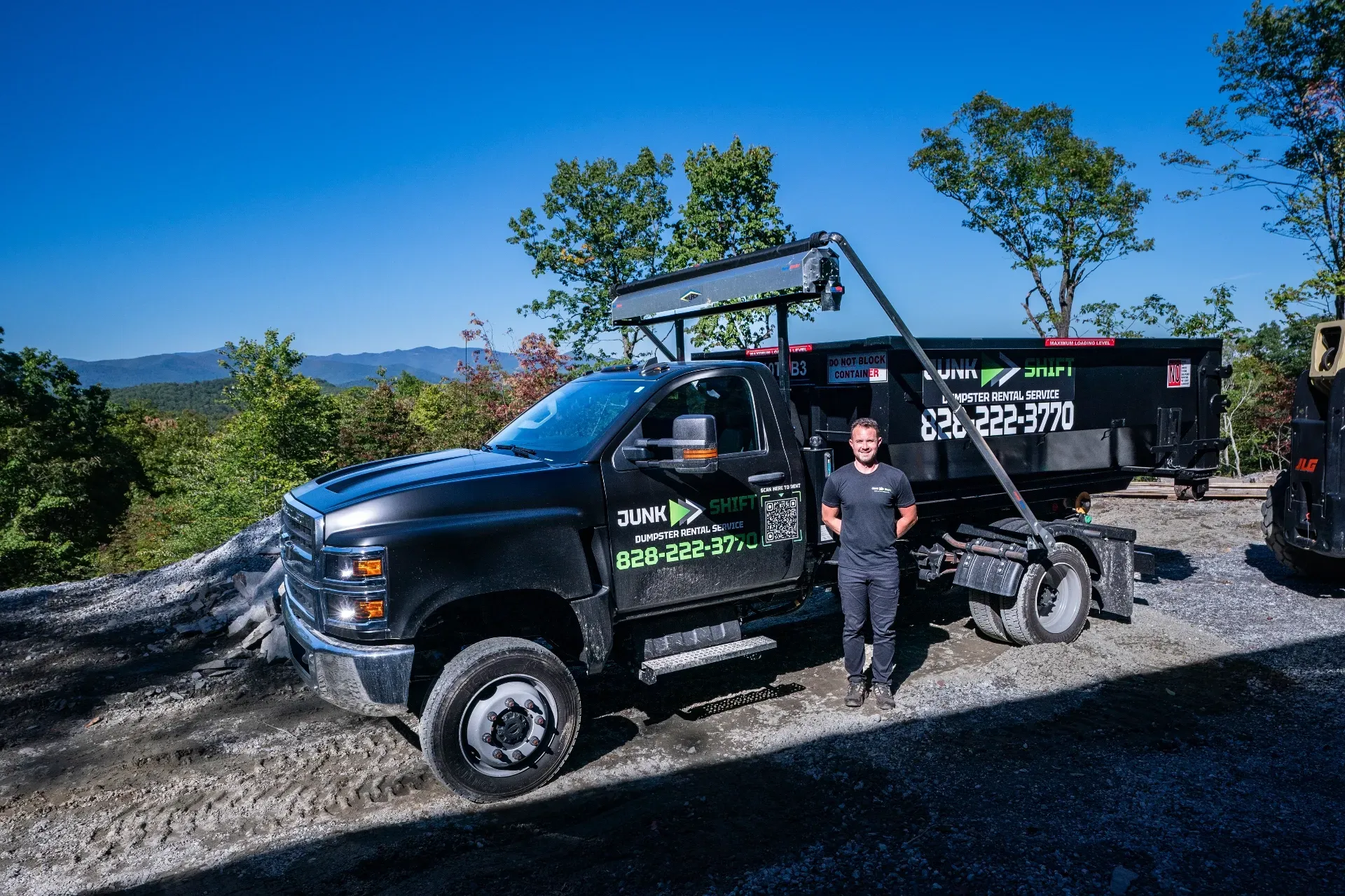 A red suv is parked in the snow in front of a house.