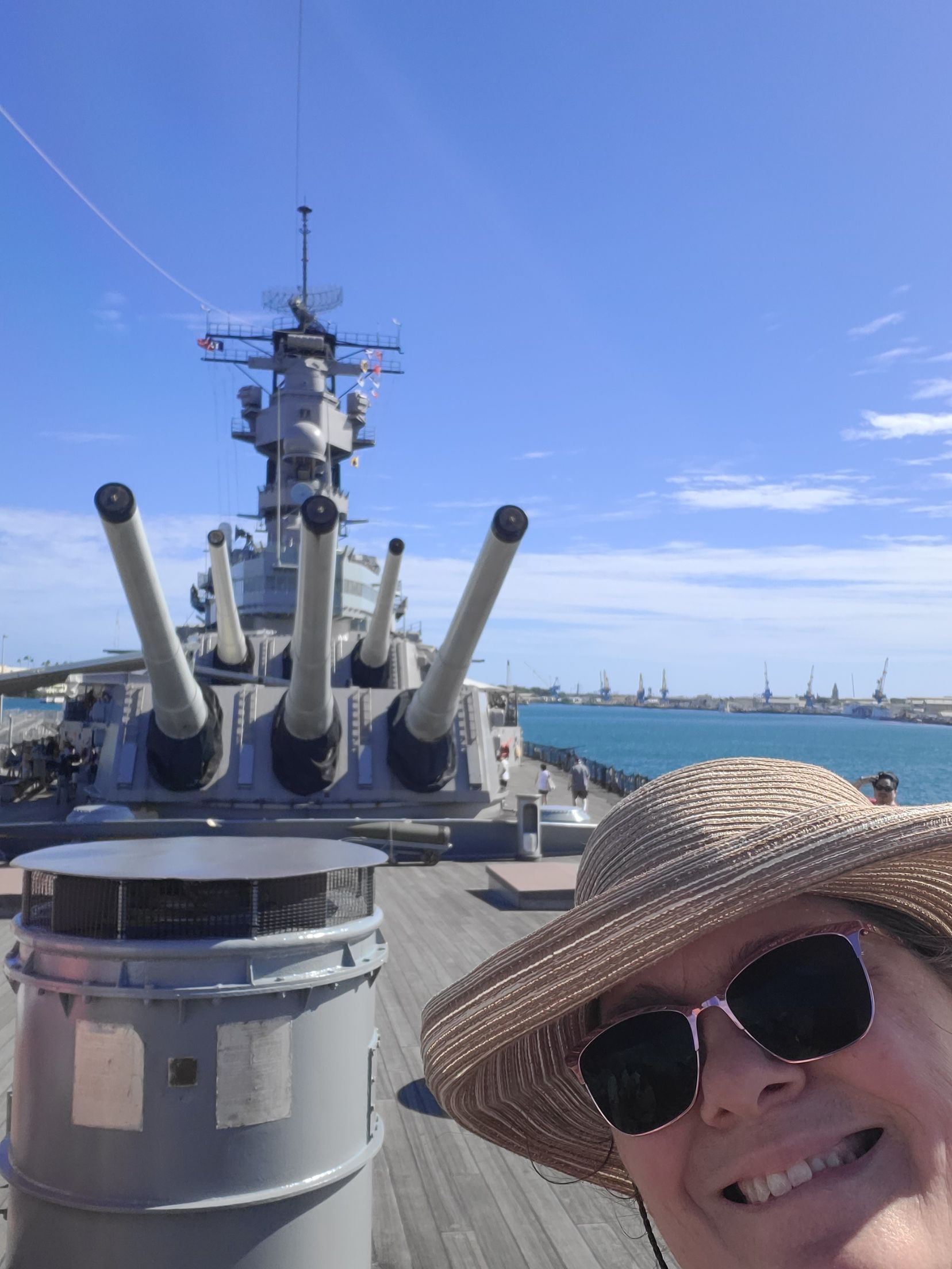 Stone Balinese temple gate with mountains and greenery in background.