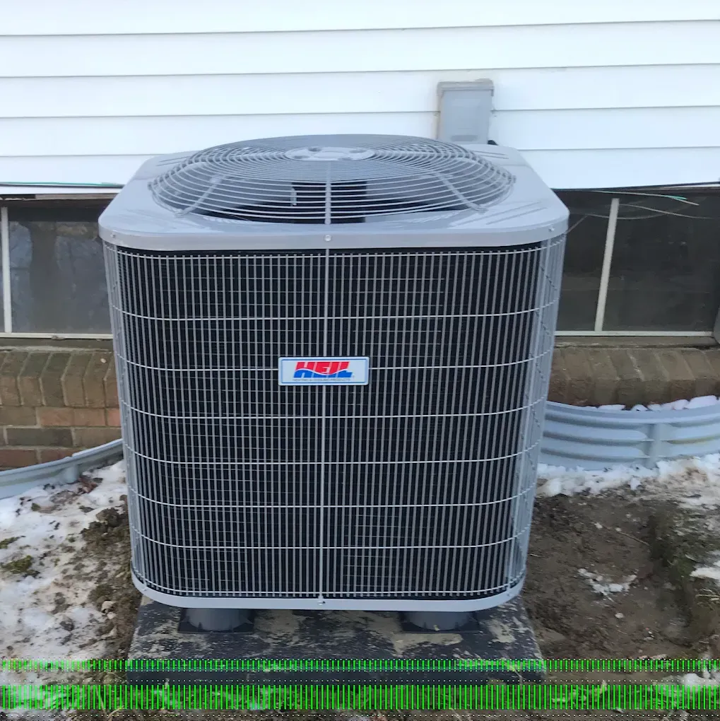 A large air conditioner is sitting outside of a house