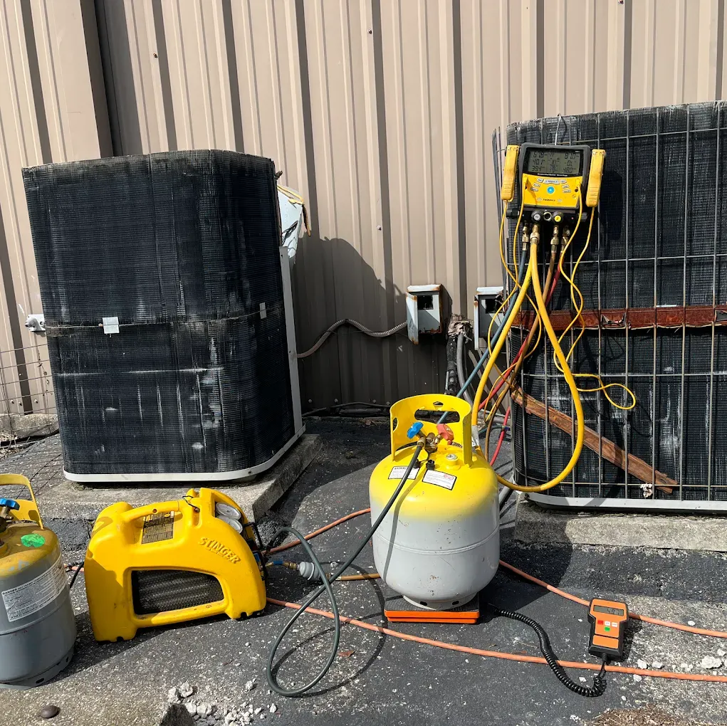 A couple of air conditioners are sitting next to each other on the side of a building.