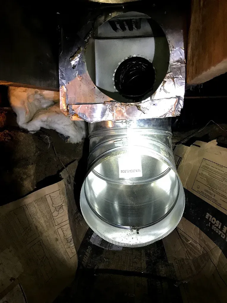 A close up of a metal pipe with a light inside of it.