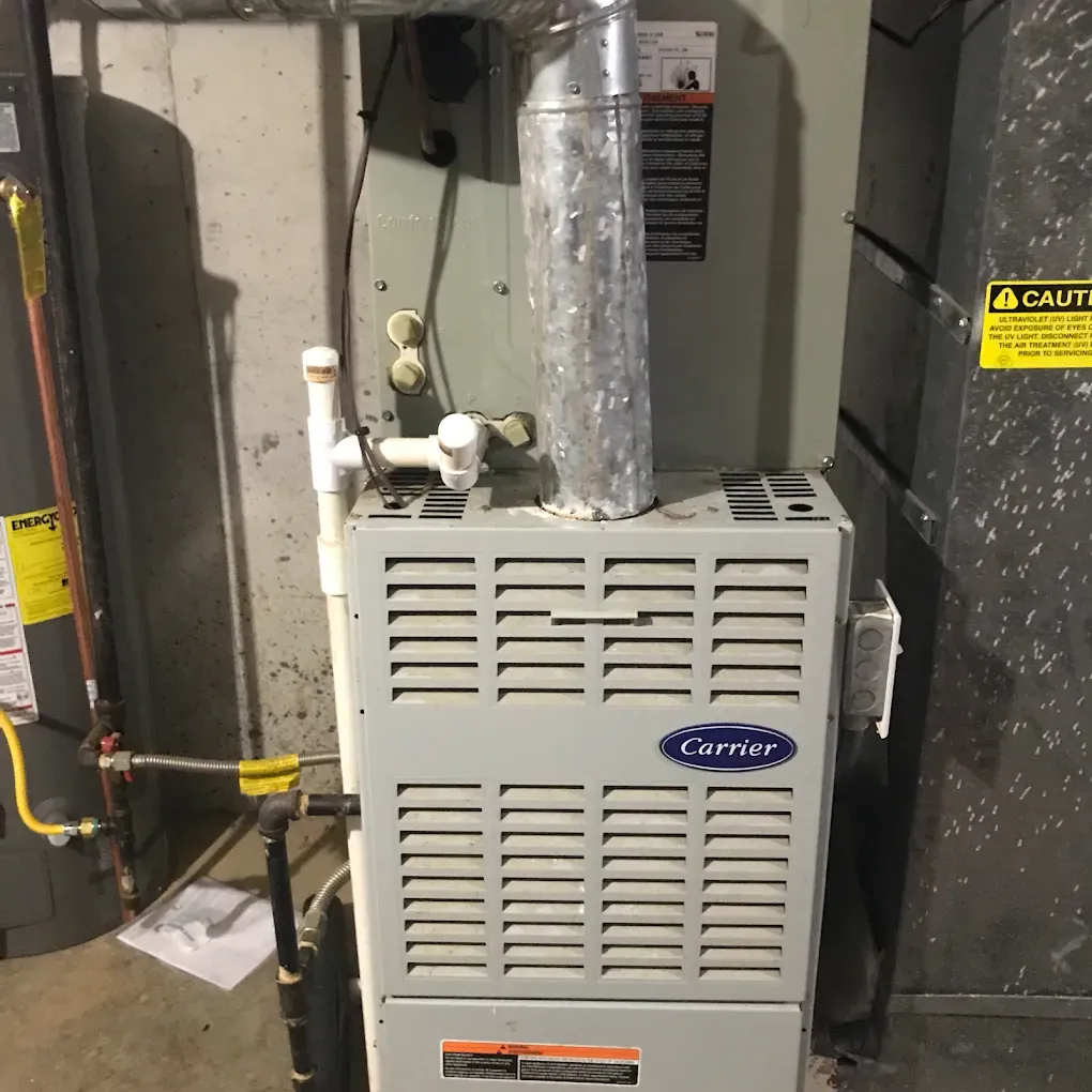 A carrier air conditioner is sitting in a basement