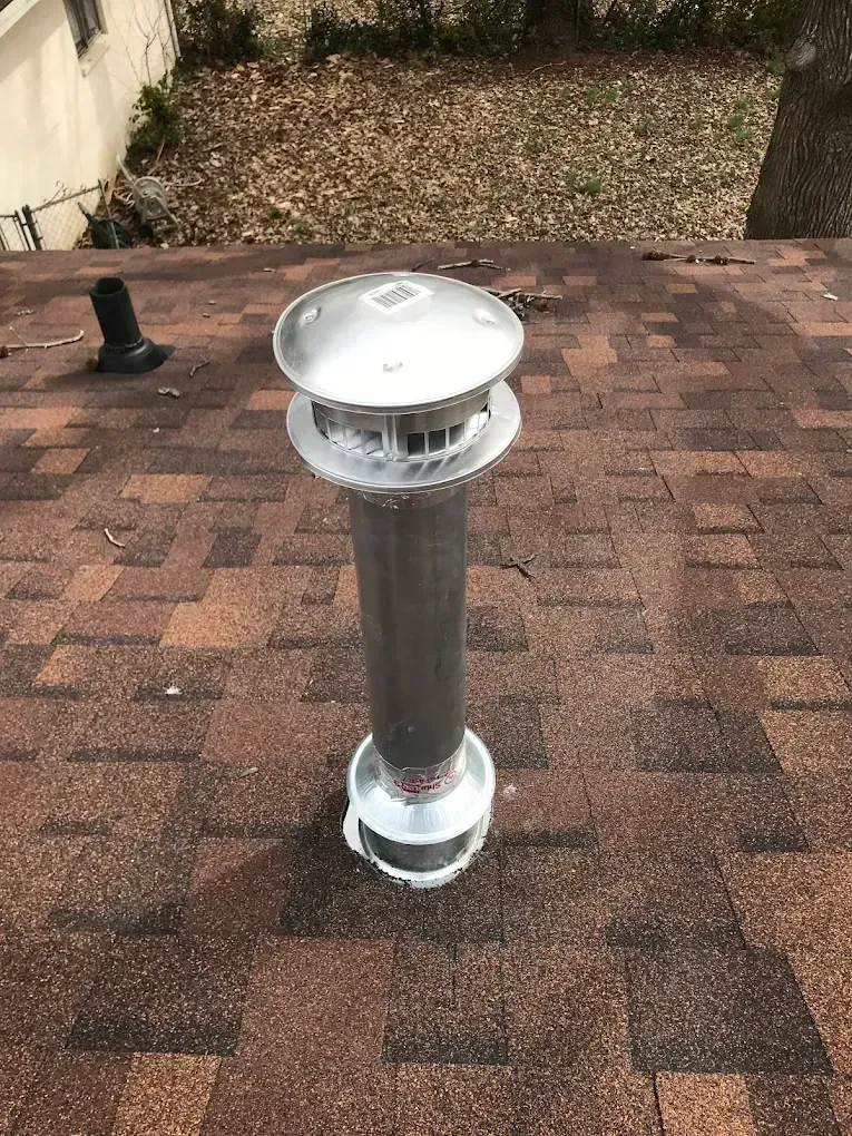 A chimney is sitting on top of a roof.