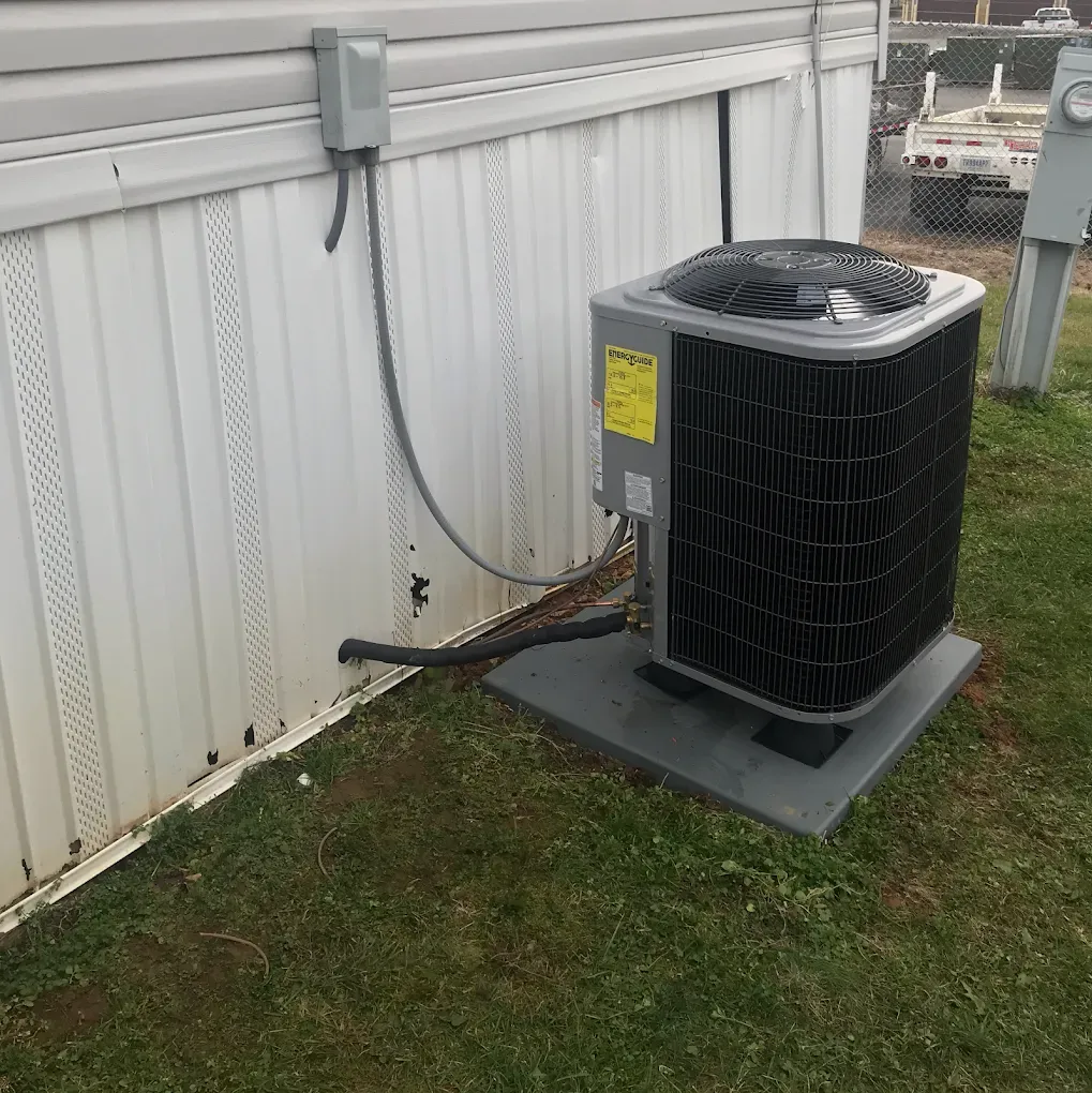 An air conditioner is attached to the side of a building