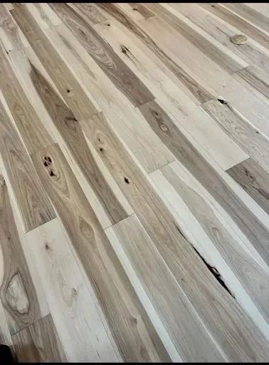 Light wood flooring with varying shades and natural grain patterns.