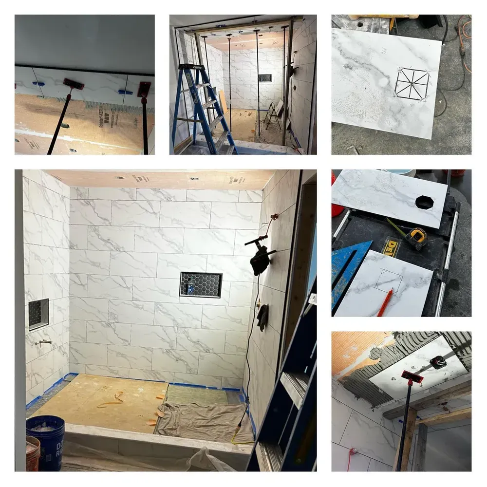 Bathroom remodel: Installation of white marble-look tiles on walls and ceiling. Tools and ladder present.