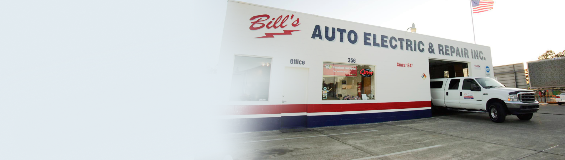 A white truck is parked in front of a bill 's auto electric repair shop | Bill's Auto Electric & Repair