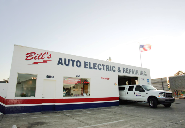 A white truck is parked in front of a bill 's auto electric & repair inc.  | Bill's Auto Electric Repair Inc