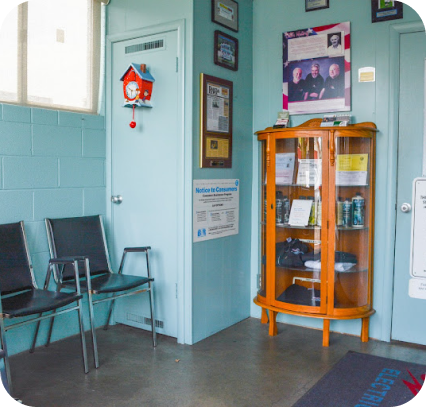 A waiting room with a sign on the wall that says notice to customers  | Bill's Auto Electric Repair Inc