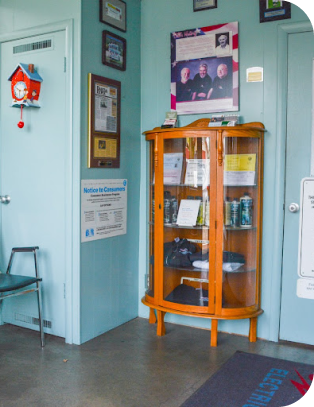 A waiting room with a sign on the wall that says notice to customers | Bill's Auto Electric Repair Inc