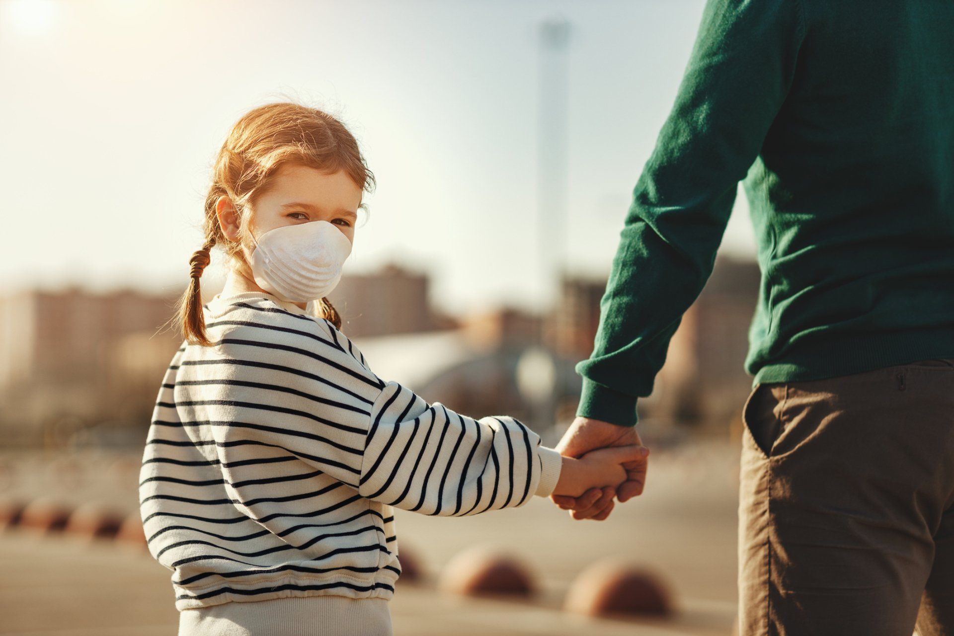 Little Girl In Medical Mask Holding Hand Of Father — Los Angeles, CA — The Law Office of Carla D. Allen