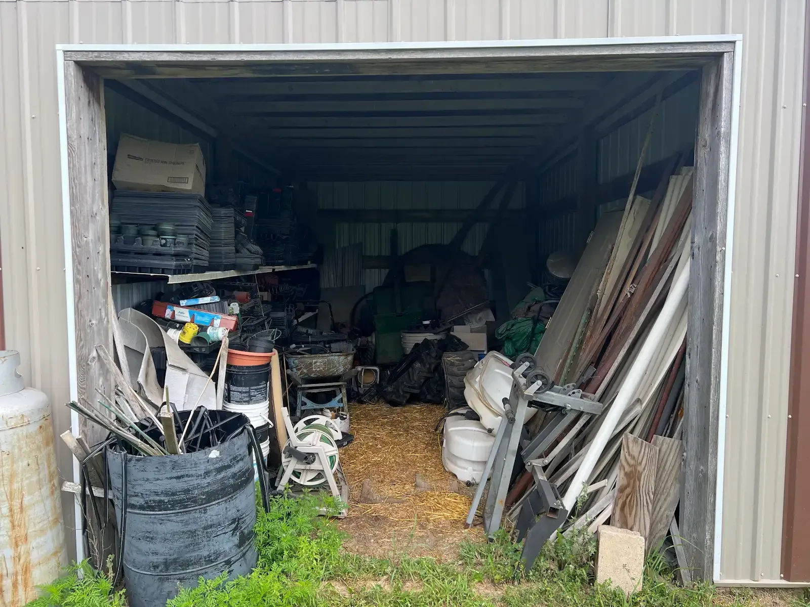 A garage filled with lots of junk and tools.