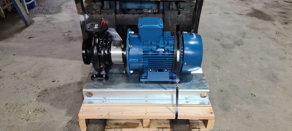 A Blue Pump Is Sitting On Top Of A Wooden Pallet — Manning Valley Pumps And Irrigation In Wingham, NSW