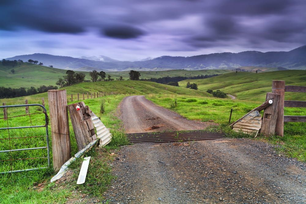 A Dirt Road Going Through A Grassy Field — Manning Valley Pumps And Irrigation In Gloucester, NSW