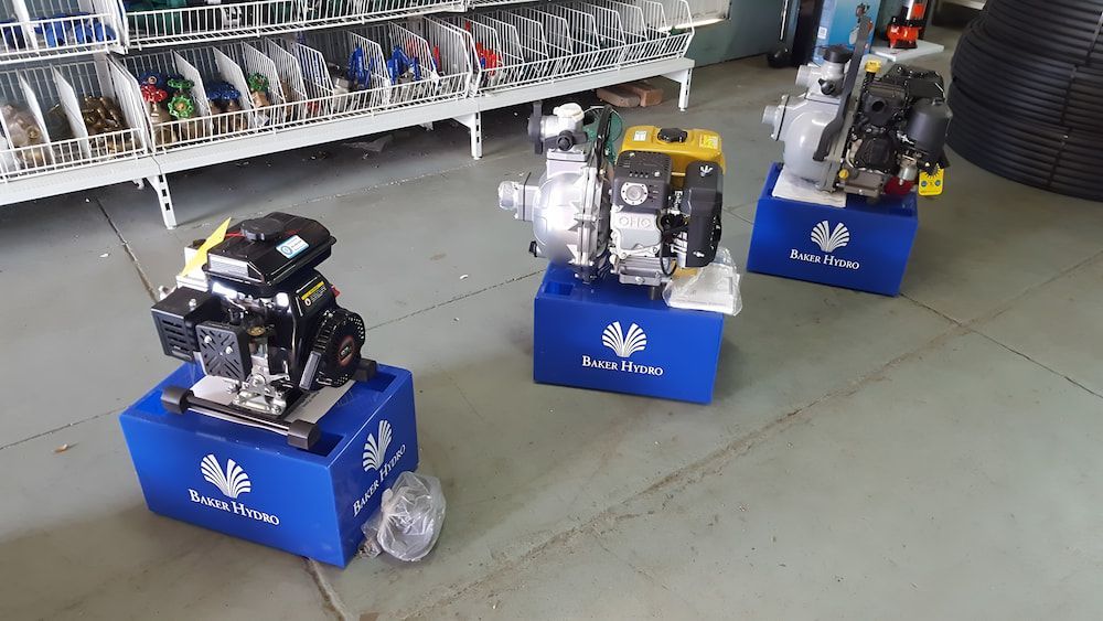 Three Pumps Are Sitting On Top Of Blue Boxes In A Store — Manning Valley Pumps And Irrigation In Wingham, NSW