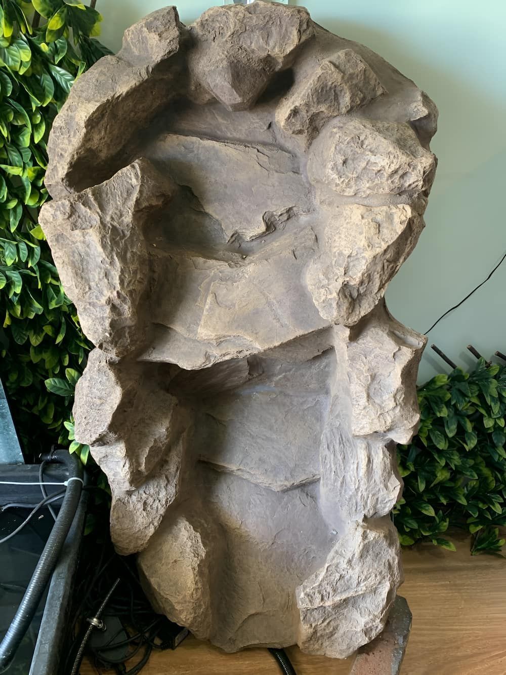 A Large Rock Is Sitting On A Wooden Table Next To A Plant — Manning Valley Pumps And Irrigation In Taree, NSW