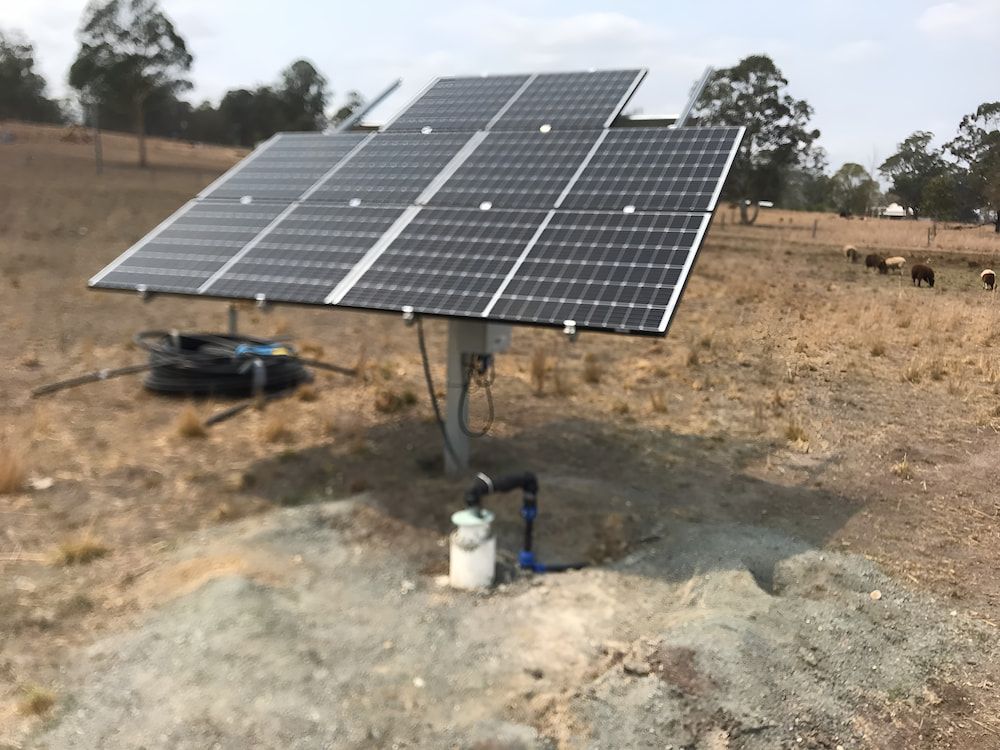 A Solar Panel Is Sitting In The Middle Of A Field — Manning Valley Pumps And Irrigation In Wingham, NSW