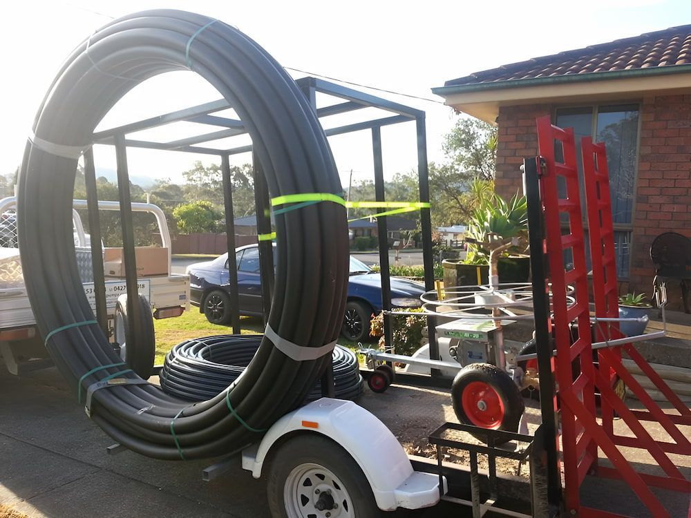 A Trailer With A Bunch Of Pipes On It — Manning Valley Pumps And Irrigation In Wingham, NSW