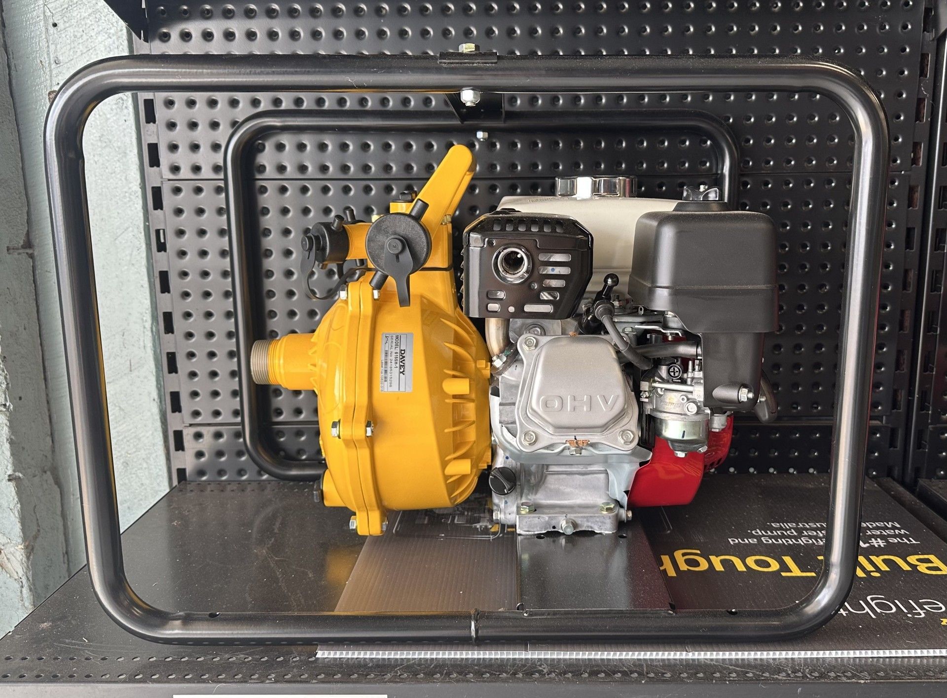 A yellow water pump with a red engine sits on a table — Manning Valley Pumps And Irrigation In Wingham, NSW