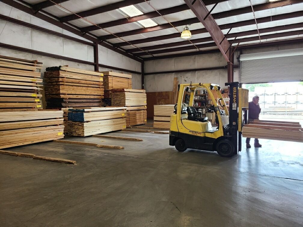 A Yellow Forklift Is Moving Wood In A Warehouse - Auburn And Redding, CA - Auburn Hardwoods