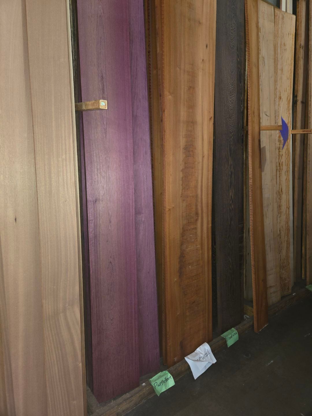 A Person Is Painting A Wooden Floor With A Brush - Auburn And Redding, CA - Auburn Hardwoods