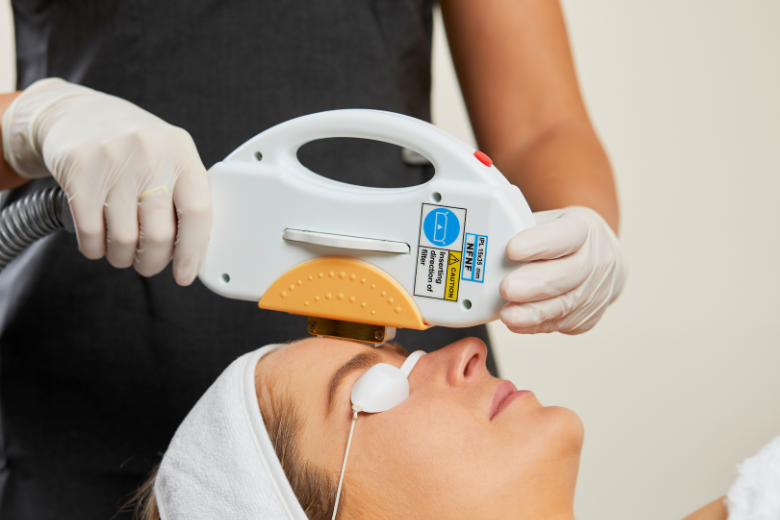 A Woman is Getting a Laser Treatment on Her Face — Aria Skin & Beauty in Gympie, QLD