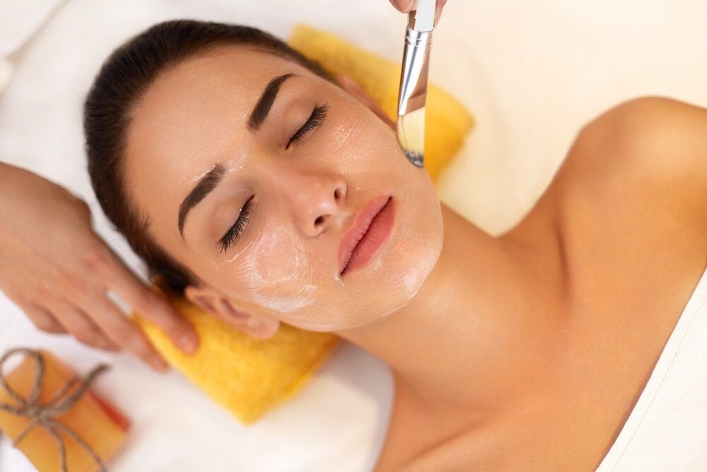 A Woman is Getting a Facial Treatment at a Spa — Aria Skin & Beauty in Gympie, QLD