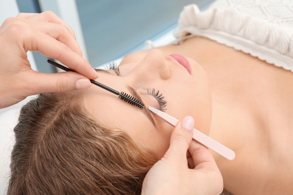 A Woman is Getting Her Eyelashes Done at a Beauty Salon — Aria Skin & Beauty in Gympie, QLD