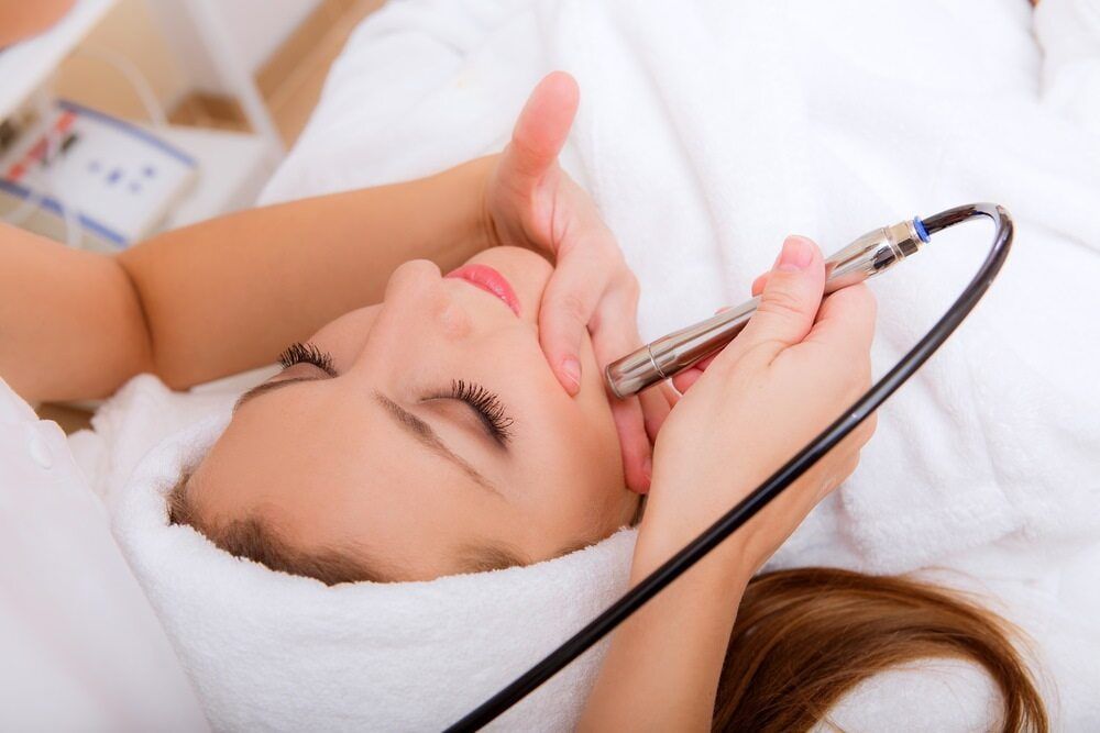 A Woman is Getting a Facial Treatment at a Spa — Aria Skin & Beauty in Gympie, QLD
