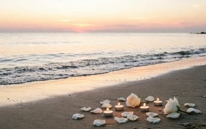 Candles and white roses on sandy beach at sunset, cremation services in Acworth GA