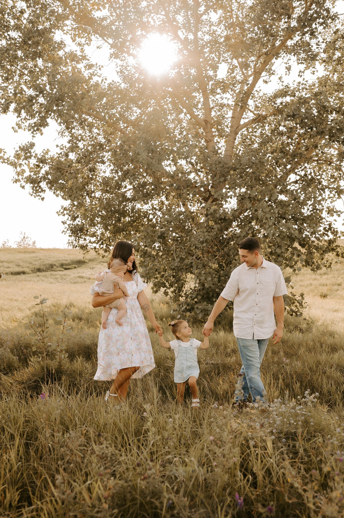 family walking in a field for candid photos