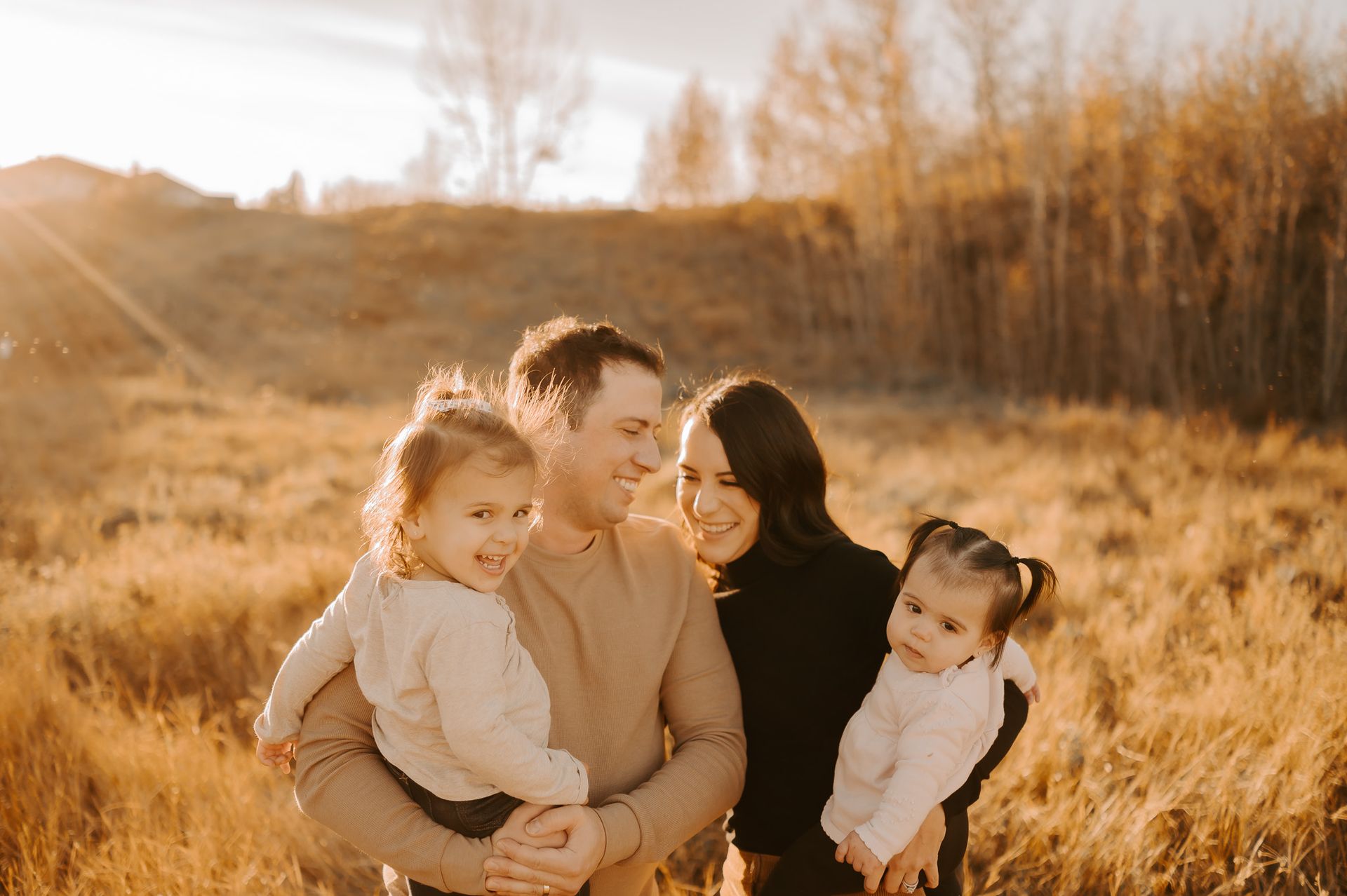 A family at golden hour posing for family photos