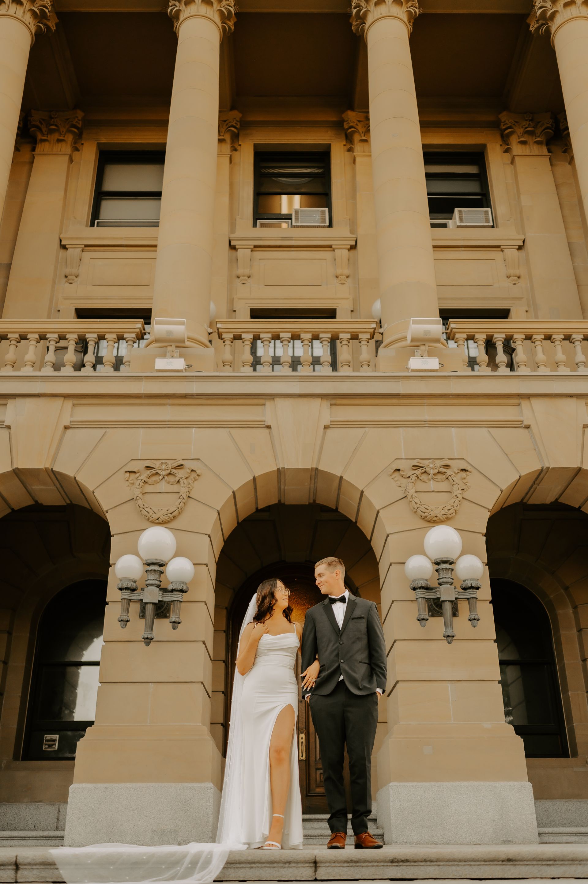 Wedding photography in Edmonton of a groom kissing the blonde bride's forehead.