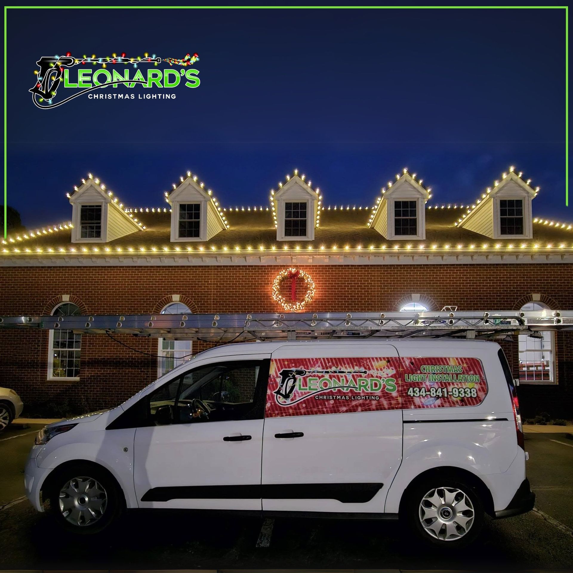 White van parked in front of a building decorated with Christmas lights, Leonard's Christmas Lighting logo.