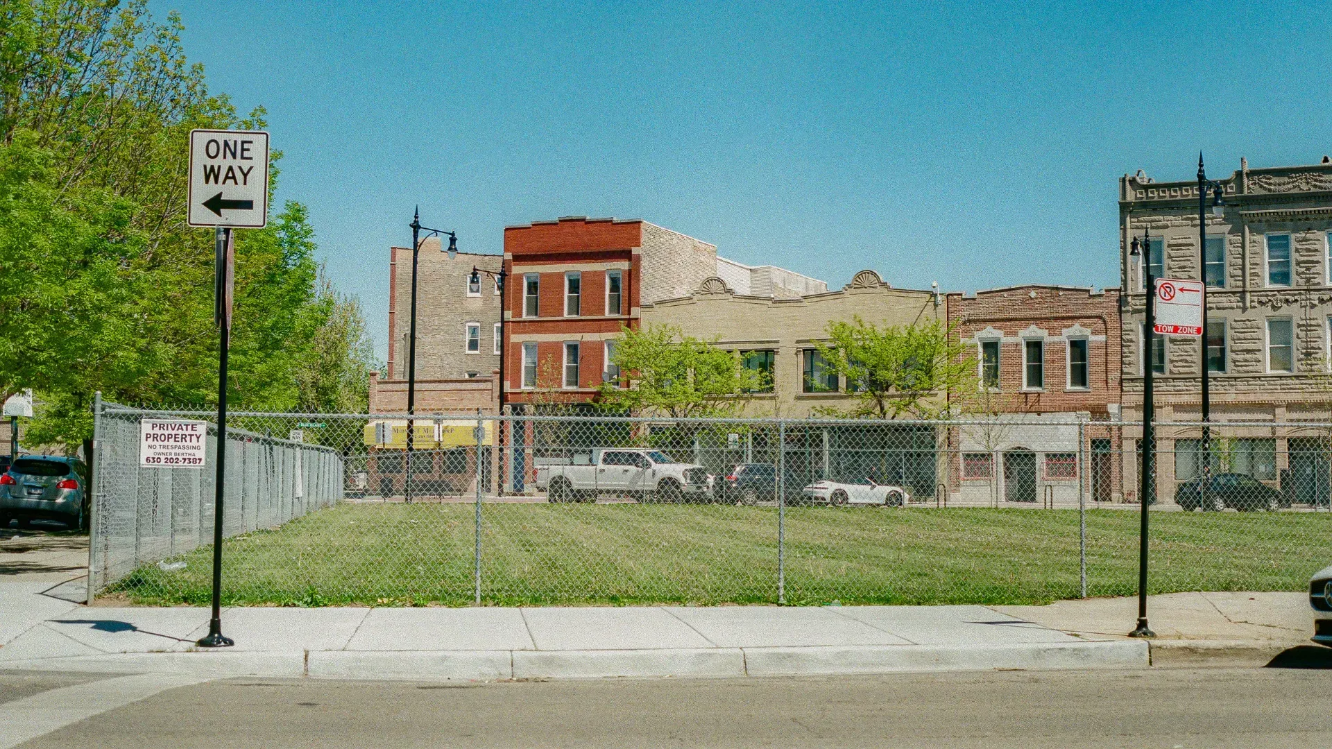 A one way sign is on the side of the road