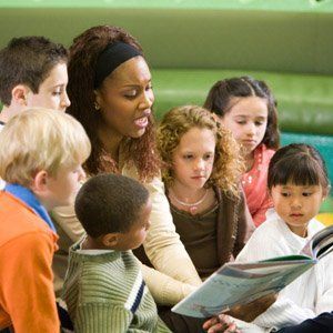 Teacher reading out to students — Children Center in Rochester, MN