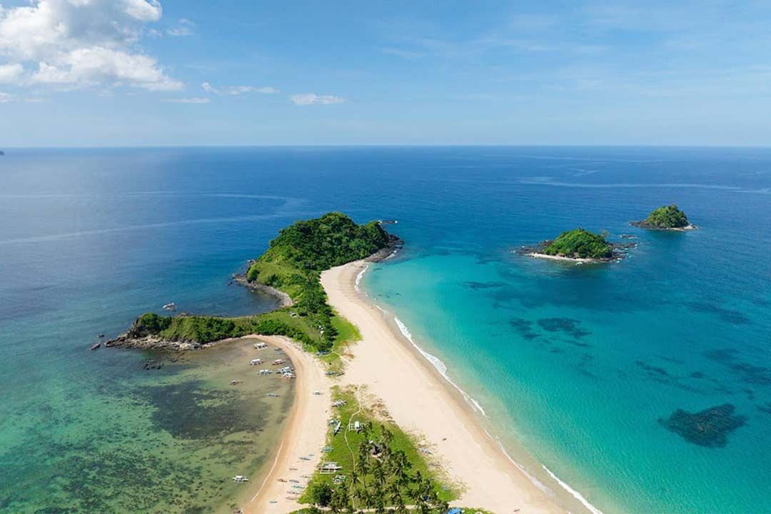 An aerial view of a small island in the middle of the ocean.