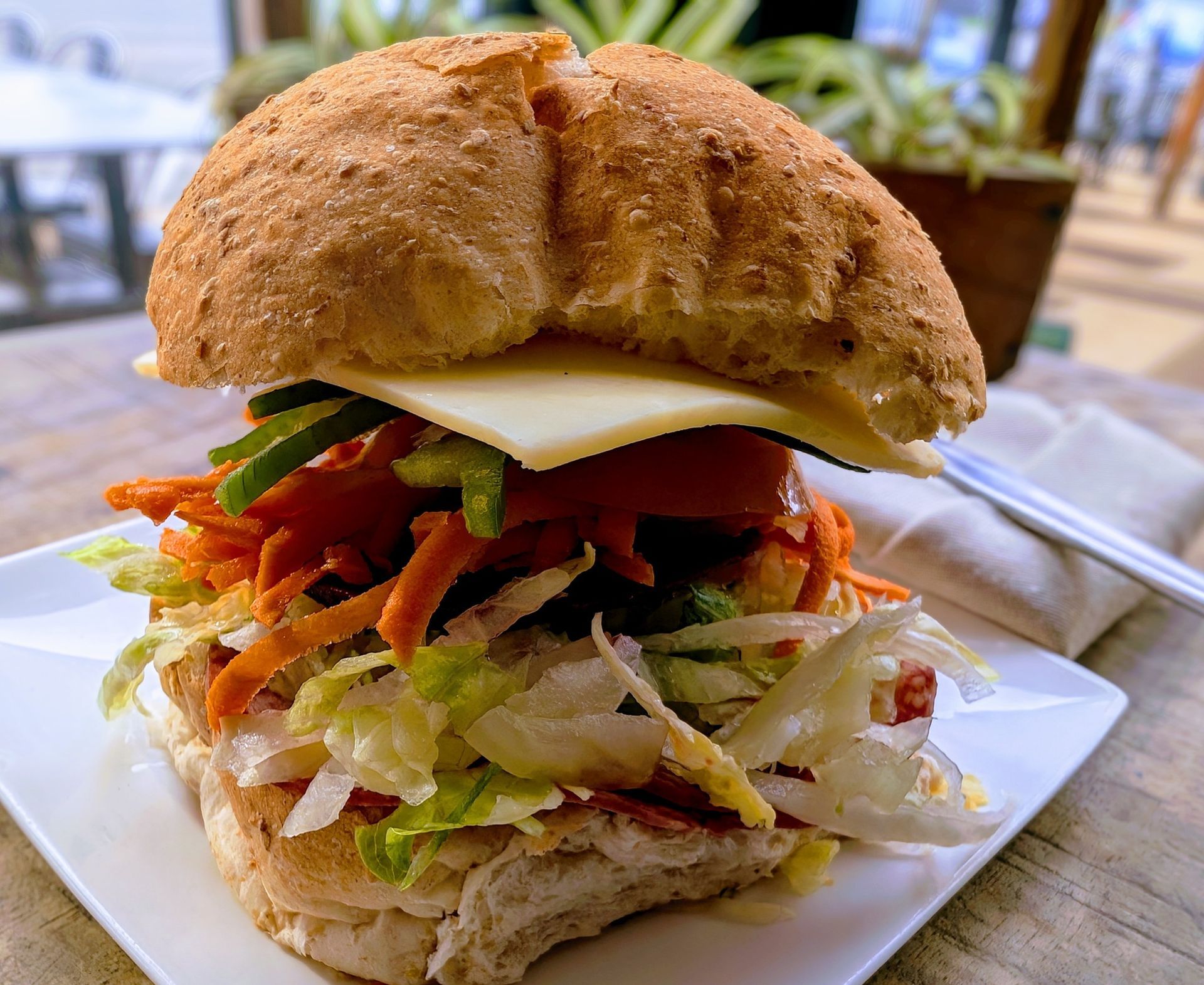 A close up of a sandwich on a plate with a fork.